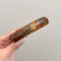 Detail of tortoiseshell spring hair clip shown on hand with elegant resin finish - Spring Barrette / Blue Brown