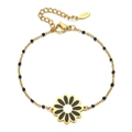 Close-up of gold stainless steel bracelet with black enamel daisy pendant and beads - Xn015 Black