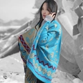 Blue cashmere shawl with gold patterns and fringes worn by a model in snow - Sunflower 4
