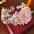 Detailed close-up of beige lace leg garter with large pink fabric rose and pearls - Pink Rose Lace Choker