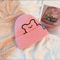 Pink knit beanie with embroidered bear motif on a decorative lace background - One Size / Pink