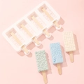 Silicone ice cream mold with textured patterns and finished popsicles on pink background - Custom Pattern Ice Cream Mold