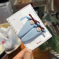 Detail of light blue fabric hair clips with red knots and heart buttons in hand - Haze Blue Heart Button Red Bow BB Clip Set