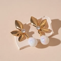 Close-up of golden leaf earrings with shimmering zircon and iridescent drop pearl charms - Gold Leaf Teardrop (Silver Pin)