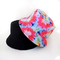 Detail of reversible bucket hat showing colorful tie-dye patterns and black cotton fabric - Rainbow Spiral Print