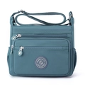 Waterproof nylon crossbody bag in teal blue with adjustable strap and multi-pocket design - Post Blue