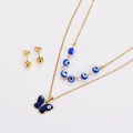 Macro view of gold-layered necklace with blue evil eye beads and butterfly pendant set - Gold Blue