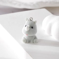 Close-up of grey flocked rhinoceros pendant with silver metal ring for DIY jewelry - Rhino