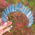 Close-up of a blue crystal crown with silver hollow moon decorations being held by hand - Blue Grey + White K Moon