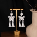 Macro detail of silver butterfly tassel earrings with floral motifs on a display stand - Flower Butterfly Tower Tassel Style E2079-5