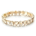 Detail of champagne heart-cut zircon stones with gold prong setting on the bracelet - Champagne