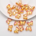 Detailed view of butterfly-shaped iridescent amber glass beads for DIY jewelry making - Gold Rose Red