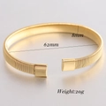 Detail view of 8mm gold elastic spring bangle showing the screw texture and dimensions - 8mm / Gold