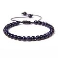 Macro view of blue sandstone beads with adjustable black braided cord and sliding knot - 6mm (Stretchable) / Blue Goldstone