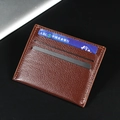 Slim brown leather card holder with three card slots and detailed stitching in lychee grain - Coffee