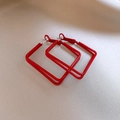 Detail of red square hoop earrings with glossy painted finish on a soft fabric backdrop - Rounded Square Style (23#)