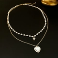 Close-up of double-layered gold necklace with heart shell pendant and pearl details - 11# Necklace - Gold Pearl Heart Double Layer