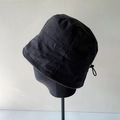 Detail of lightweight black bucket hat featuring corduroy texture and adjustable drawstring - Black