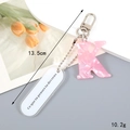 Detail of pink acrylic letter K keychain and French engraved tag with 13.5cm size mark - Letter K