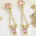 Detail of bear stud earrings with pink heart stones and star accents on white stone - Long Saturn Bear (ES2289)