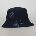 Macro detail of bucket hat with Power of Love graphic and white hand-drawn art - Black