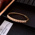 Bracciale rigido dorato con motivi a cuore e zirconi cubici incastonati a pavé - Stile con Motivo a Ventaglio / Oro-Ventaglio