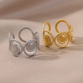 Detail of twisted rope design rings in gold and silver finish with adjustable open bands - Braided Vintage Rings