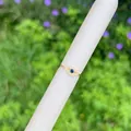 Macro detail of 18K gold Evil Eye ring featuring blue gemstone and zircon on white stand - Evil Eye-Blue Stone