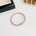 Pink high elasticity hair tie featuring a rectangular gold charm with small rhinestones - Pink