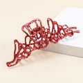 Dettaglio di un fermaglio per capelli rosso irregolare in metallo con pois bianchi - Rosso (B3302)
