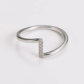Macro shot of silver wavy stainless steel ring featuring 6 small zircon stones - US 6 / Steel