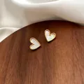 Elegant gold-framed heart stud earrings with natural white mother-of-pearl inlay - White