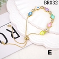 Detailed macro of colorful enamel Hamsa hand charms on a gold adjustable slider bracelet - Colorful