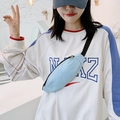 Sky blue minimalist canvas chest bag for women in a casual cross-body style on a model - Light Blue