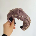 Detail of knotted grey-pink satin headband with hand-sewn sparkling rhinestones - Purple