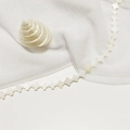 Macro shot of natural white mother of pearl shell clover beads for jewelry making - 12mm