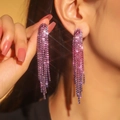 Luxurious pink and purple gradient rhinestone tassel long earrings worn by a model - 3D Style / Pink Purple Gradient