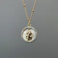 Detail of Virgin Mary relief on white mother-of-pearl pendant with blue zircon frame - Style C (Round Mary - Blue Zircon)