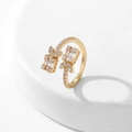 Vista macro dell'anello aperto dorato con intarsi di zirconi cubici a baguette e tondi - Stile 5 / Oro