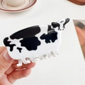 Simpatica molletta per capelli in acetato con stampa mucca bianca e nera e finitura lucida - Acetato / Mucca