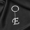 Polished silver stainless steel alphabet keychain featuring letter E on black silk - Letter E