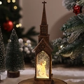 Gros plan d'une lanterne église boule à neige en bronze avec lumière LED et ange décoratif - Église à Eau Ange
