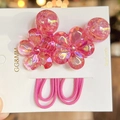 Detail of pink camellia resin hair rings with diamond centers and gold foil beads - Rose Red