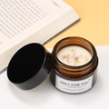 Handmade soy wax aromatherapy candle in amber glass jar with dried flower petals - Osmanthus Rain