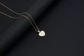 Detail of 18k gold heart necklace featuring a white shell inlay with letter C charm - Shell Heart Letter C (With Chain)