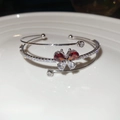 Macro-detail van de zilveren vlinderarmband met rode en witte zirkonia's en dubbele laag - Rood