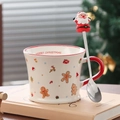 Detail of Christmas ceramic mug with gingerbread patterns and Santa Claus spoon topper - Gingerbread Man (With Spoon)