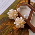 Elegant floral stud earrings featuring cream petals and central pearl with gold-toned finish - Champagne Petal Pearl