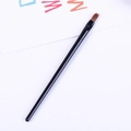 Detail of a thin black handle makeup brush with brown pointed tip for eyeliner and precision - 13cm Long / Black