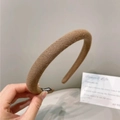 Detailed close-up of brown knitted vintage headband with a handmade label - Brown